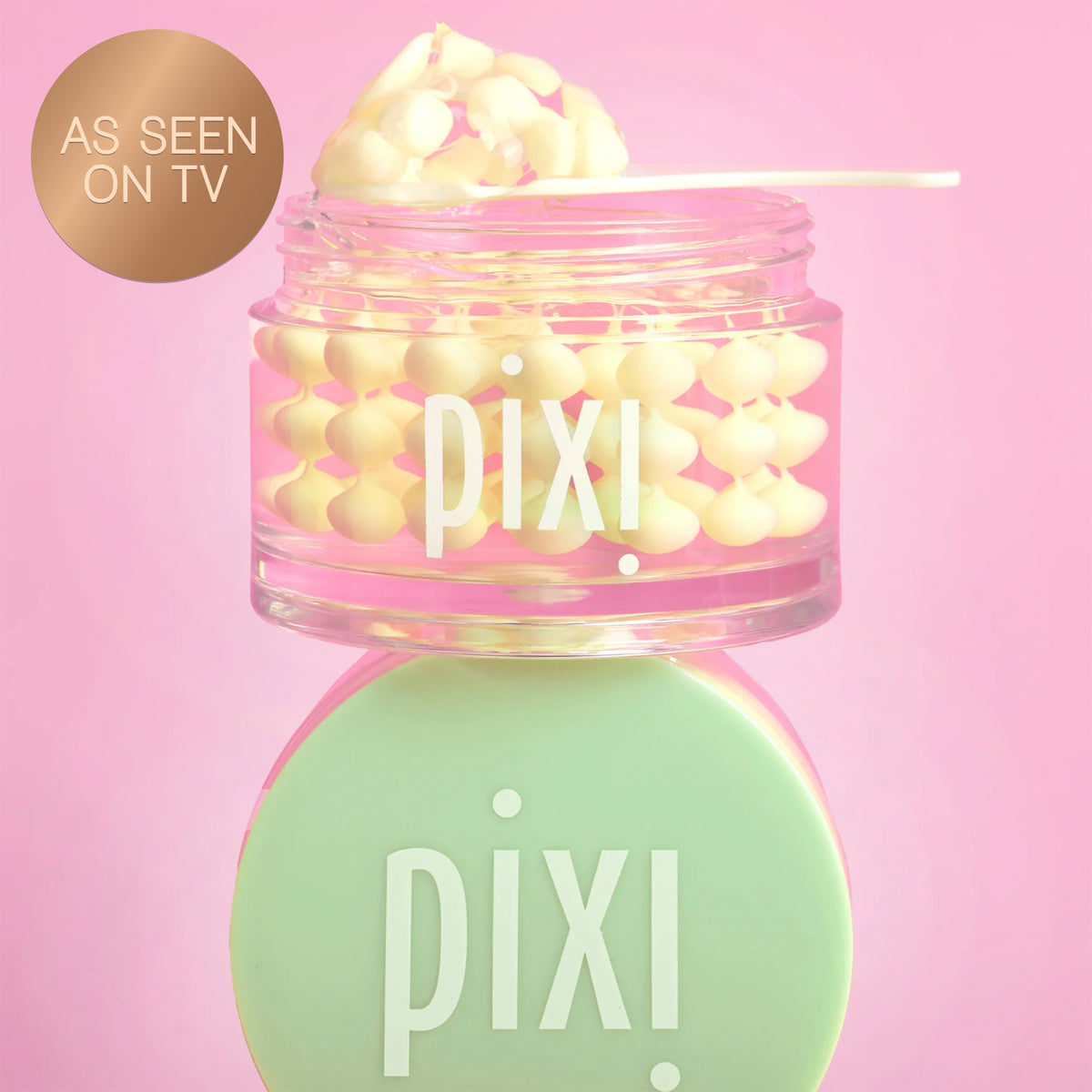 Pixi Vitamin-C CreamSerum product with pink lid and green cap on a pink background and a "As Seen on TV" badge