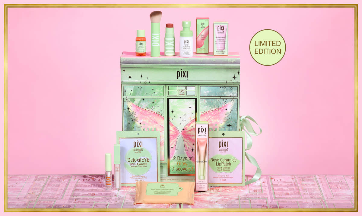 Pixi Advent Calendar gift set displayed on a pink background, featuring a mint green fairy-themed trunk with pink wings, surrounded by skincare and makeup products including DetoxEYE, Rose Ceramide LipPatch, and a small bottle, with a 'LIMITED EDITION' badge. View 1