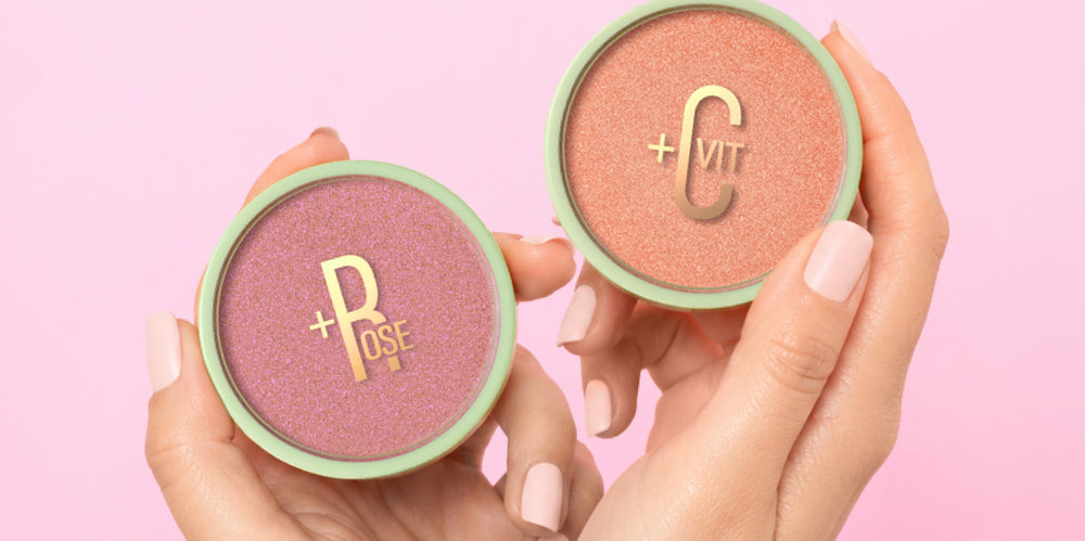 Glow-y Powder in Rose and Vitamin C shown in hand on a pink background - View 2