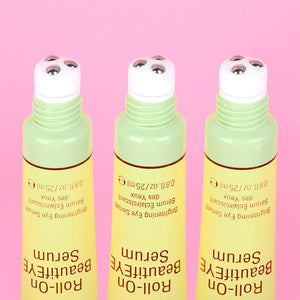 Three bottles of BeautifEYE Roll-On Serum on a pink background - close up of rollerball