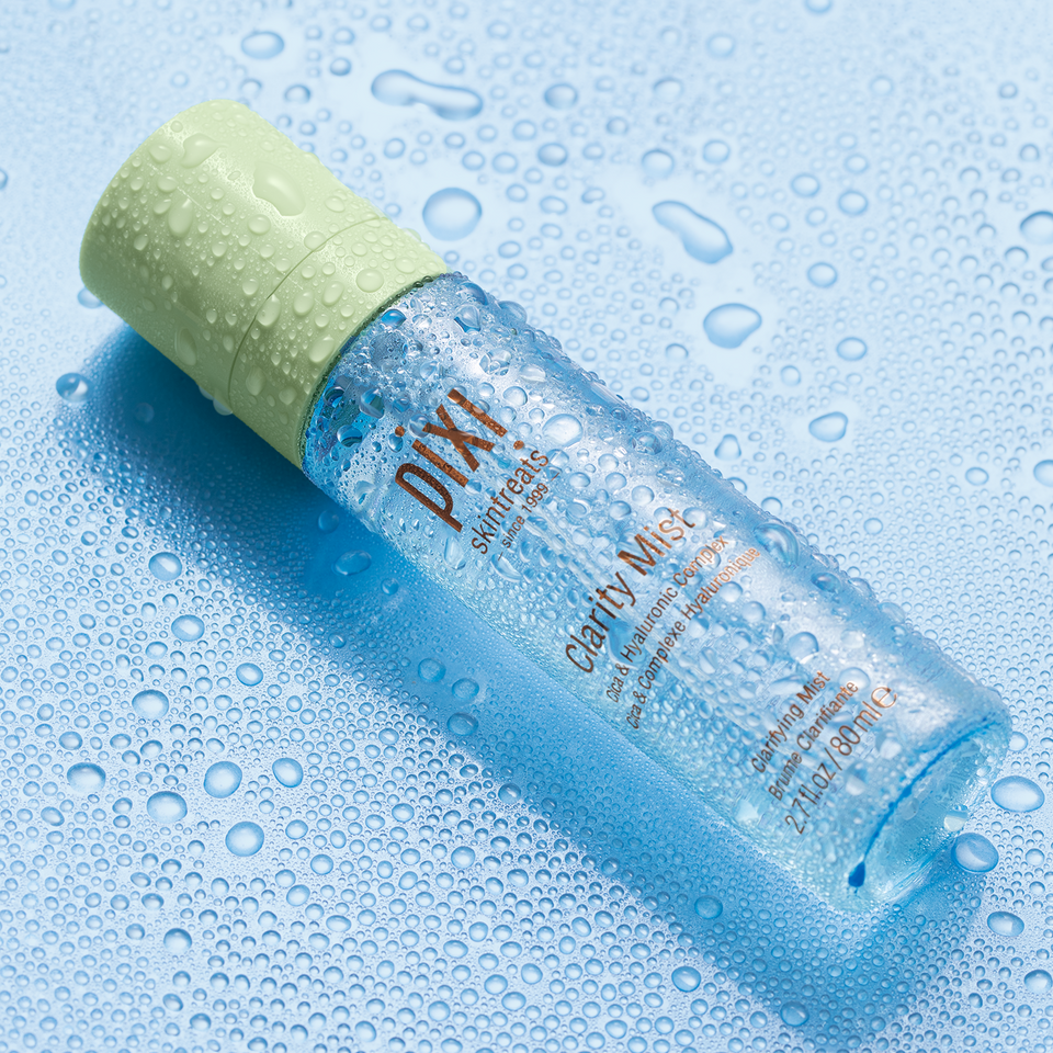 Clarity Mist shown on a blue background with water droplets view 2