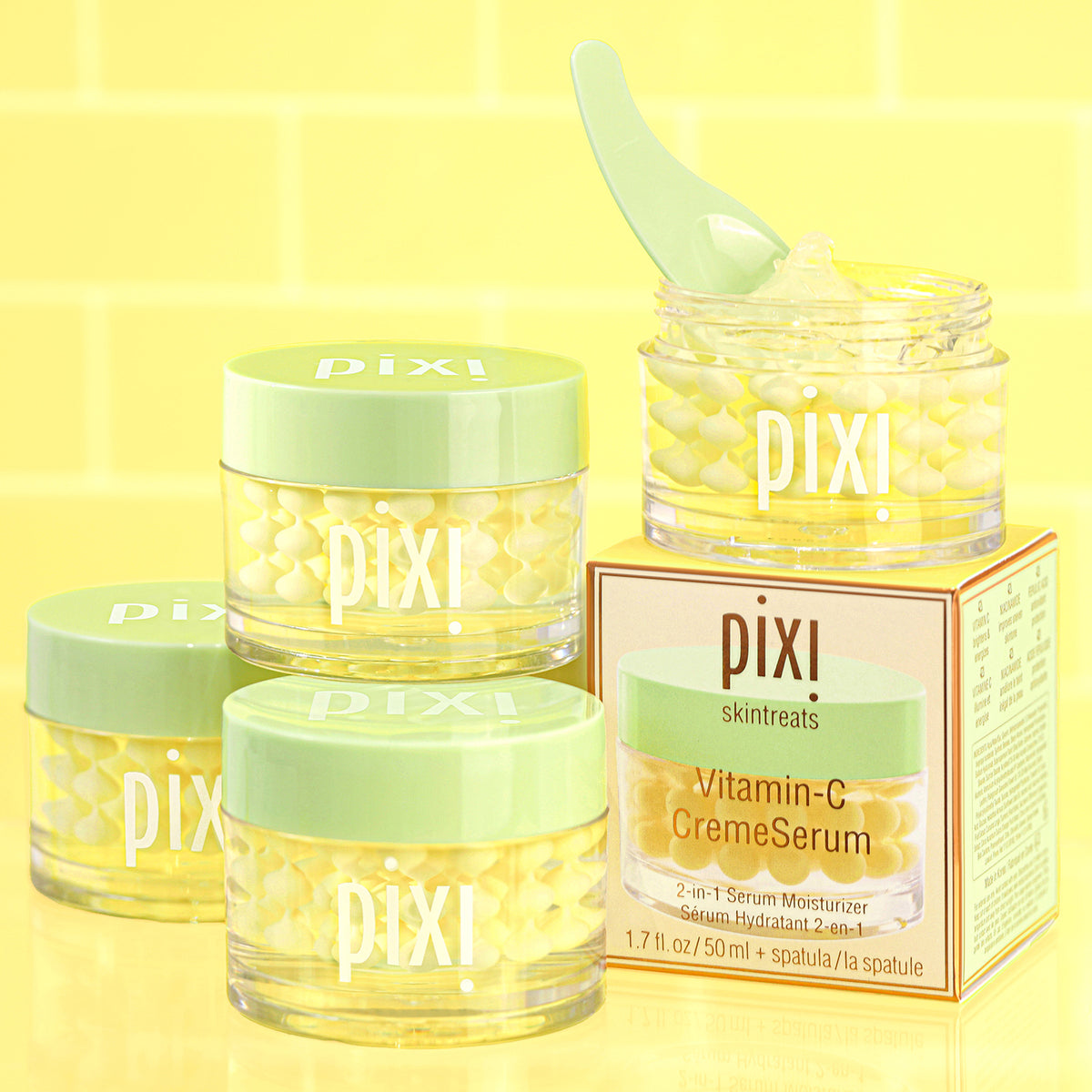 Pixi skincare Vitamin-C CremeSerum including jars and a box on a yellow background